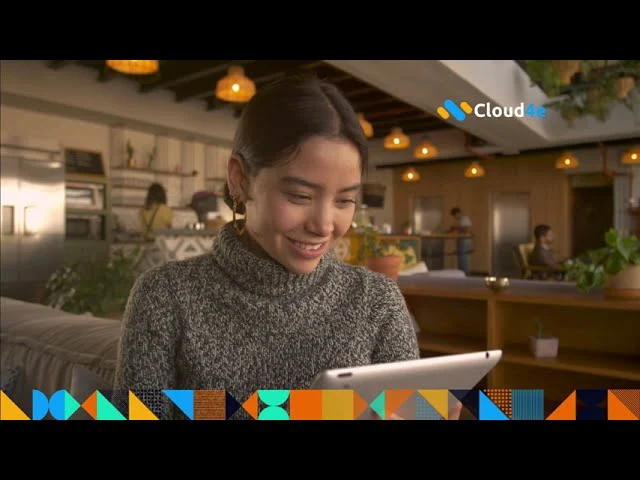 a woman smiling while holding a tablet